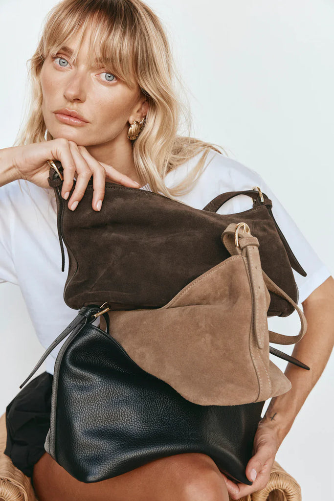 6 colourful leather bags stacked on top of each other